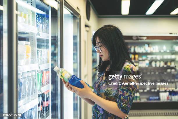 asian woman shopping in the supermarket - customer segments stock pictures, royalty-free photos & images