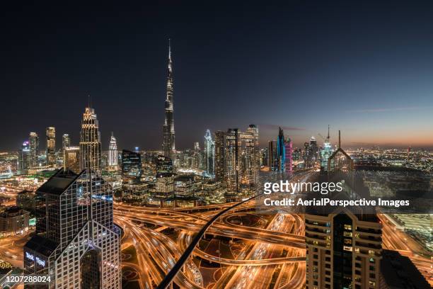 high angle view of dubai skyline at night - expo 2020 dubai stock pictures, royalty-free photos & images