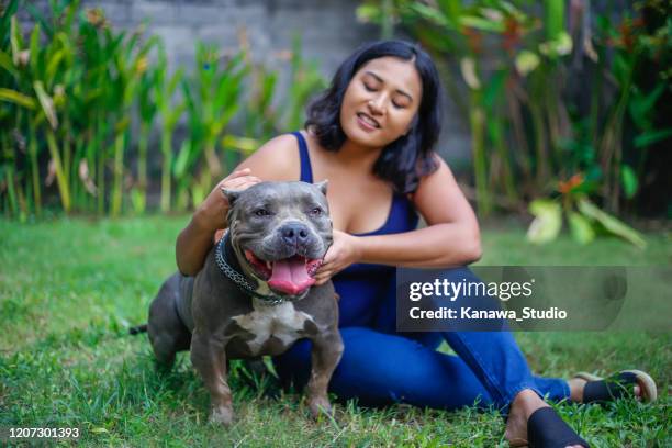 asian woman taking care her best friend - american bulldog stock pictures, royalty-free photos & images