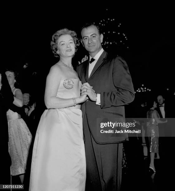 Actress Myrna Loy dances with an unidentified man during the Mayfair Supper Dance in the Plaza Hotel's Terrace Ballroom, November 5, 1960.