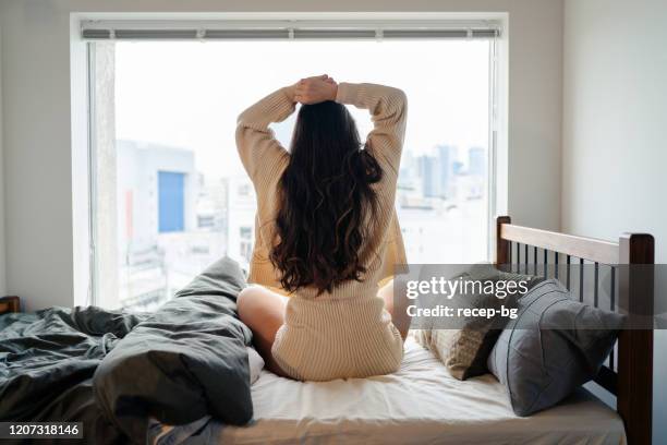 young woman waking up in the morning - morning bed stretch stock pictures, royalty-free photos & images