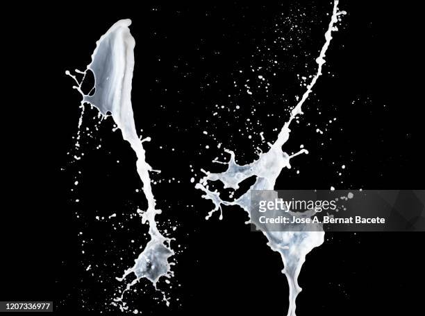 figures and abstract forms of milk on a black background. - milk wave stock pictures, royalty-free photos & images