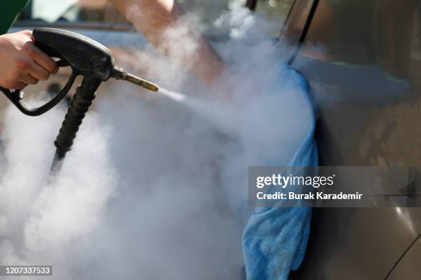 car detailing. car washing cleaning engine. cleaning car using hot steam. hot steam engine washing. soft lighting. car wash man worker cleaning vehicle. - steam power stock pictures, royalty-free photos & images