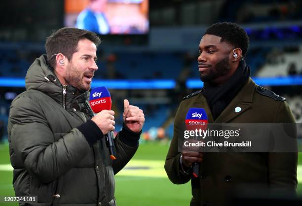 Presenter and former footballer Jamie Redknapp talks to former Manchester City player Micah Richards prior to the Premier League match between...