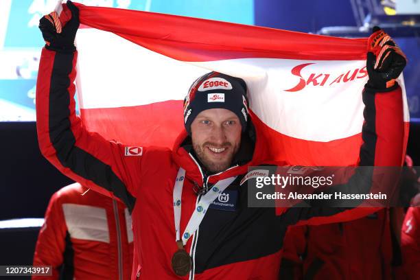 Dominik Landertinger of Austria celebrates winning the Bronze medal at the medal ceremony for the Men 20 km Individual Competition at the IBU World...