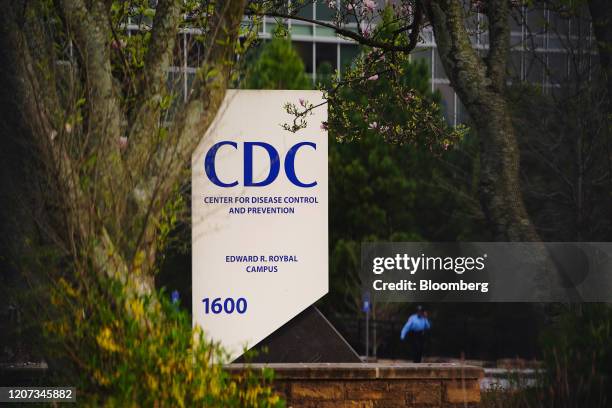 Security guard walks on the grounds of the Centers for Disease Control and Prevention headquarters in Atlanta, Georgia, U.S, on Saturday, March 14,...