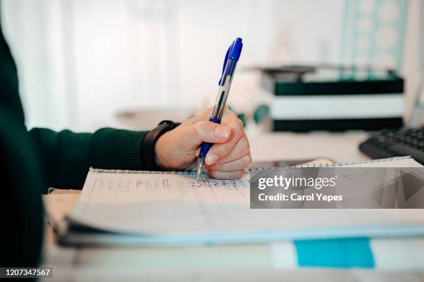 closeup teenager boy doing homework - left hand writing stock pictures, royalty-free photos & images