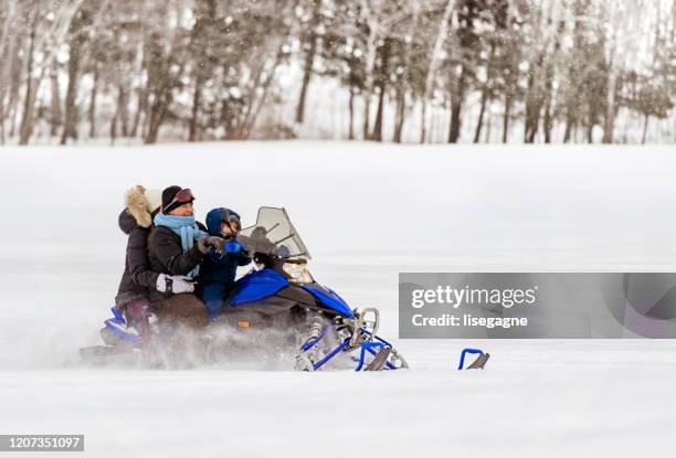 family weekend in winter - snowmobile stock pictures, royalty-free photos & images