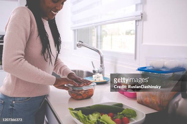 a woman keeping leftovers. - container stock pictures, royalty-free photos & images