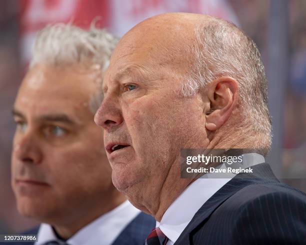 Head coach Claude Julien of the Montreal Canadiens talks to Assistant coach Dominique Ducharme on the bench during an NHL game against the Detroit...