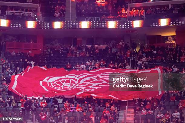 Giant Detroit Red Wings flag is passed around the rink by the fans before the start of an NHL game against the Montreal Canadiens at Little Caesars...