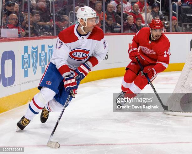 Ilya Kovalchuk of the Montreal Canadiens skates around the net with the puck next to Robby Fabbri of the Detroit Red Wings during an NHL game at...