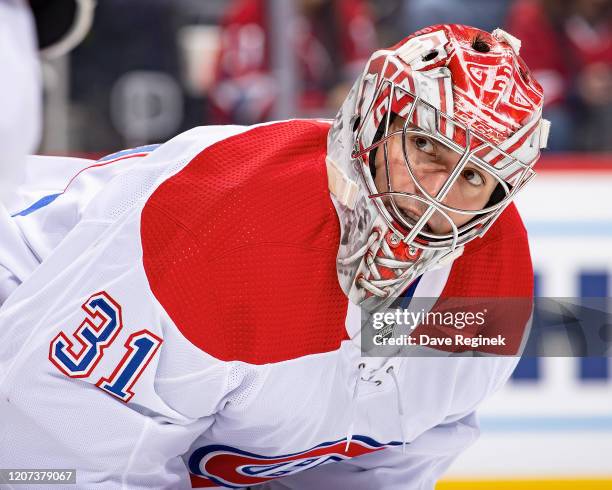 Carey Price of the Montreal Canadiens looks over at a teammate on a play stoppage during an NHL game against the Detroit Red Wings at Little Caesars...