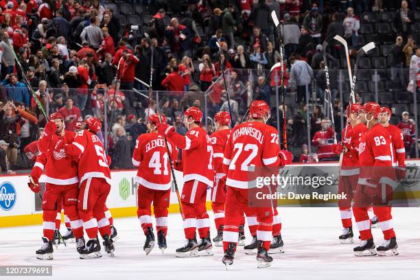 Andreas Athanasiou of the Detroit Red Wings and teammates salute the fans after an NHL game against the Montreal Canadiens at Little Caesars Arena on...