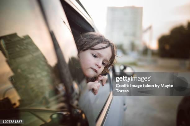 boy sticking face out of the car window - car rear view mirror stock pictures, royalty-free photos & images