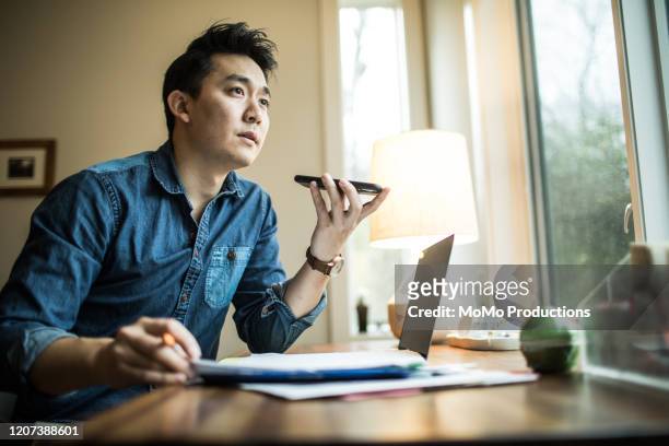 man (early 30s) working in home office - business man sitting banking imagens e fotografias de stock