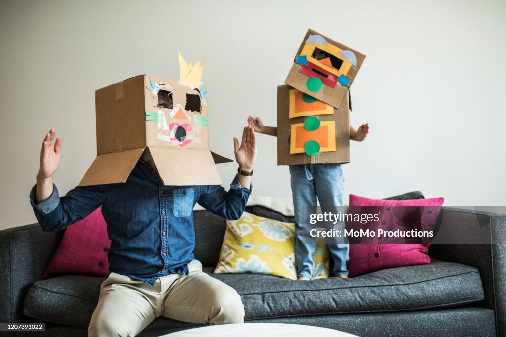 Father and daughter wearing robot costumes at home