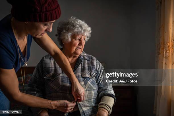 portrait of an old portuguese woman with her daughter. - help getting dressed stock pictures, royalty-free photos & images