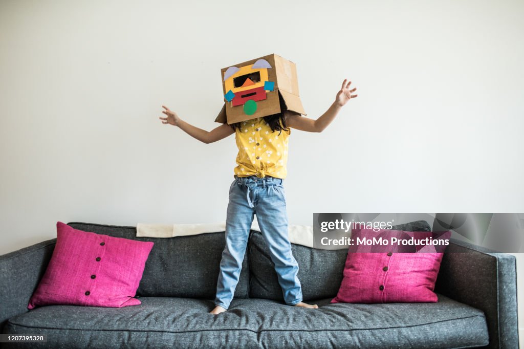 Young girl wearing robot costume at home
