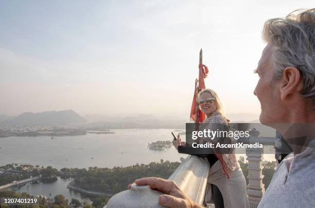 mature couple look off to view from hillside - udaipur imagens e fotografias de stock