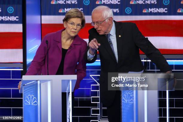 Democratic presidential candidates Sen. Elizabeth Warren and Sen. Bernie Sanders speak during a break during the Democratic presidential primary...