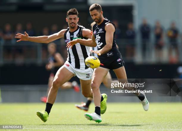 Kade Simpson of the Blues kicks the ball under pressure from Scott Pendlebury of the Magpies during the AFL Practice Match between the Carlton Blues...