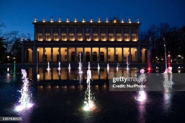 Fountain in front of the Romolo Valli Theater illuminated with the Italian tricolor colors during COVID-19 pandemic in Italy on March, 2020 in Reggio...