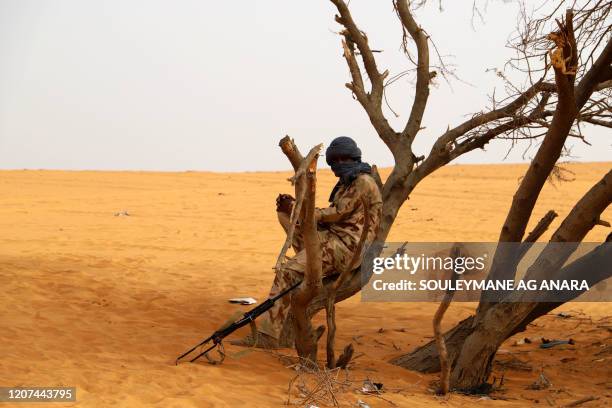 Militant from the Movement for the Salvation of Azawad , a Tuareg political and armed movement in the Azawad Region in Mali, rests in the desert...