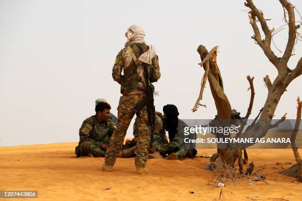 Militants from the Movement for the Salvation of Azawad , a Tuareg political and armed movement in the Azawad Region in Mali, rest in the desert...