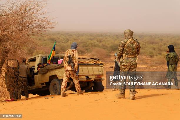 Militants from the Movement for the Salvation of Azawad , a Tuareg political and armed movement in the Azawad Region in Mali, rest in the desert...