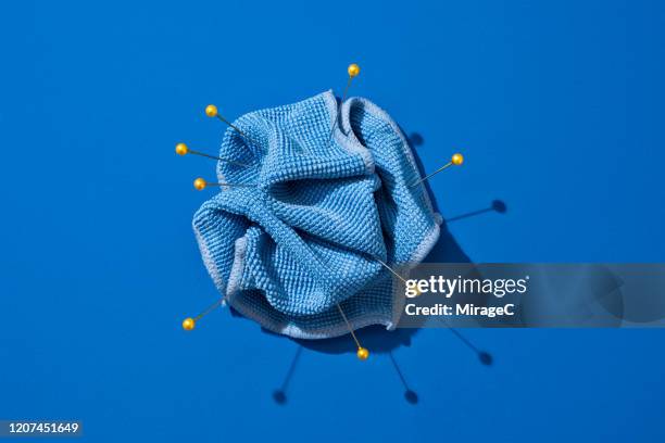 pinned blue textile - nadelkissen stock-fotos und bilder