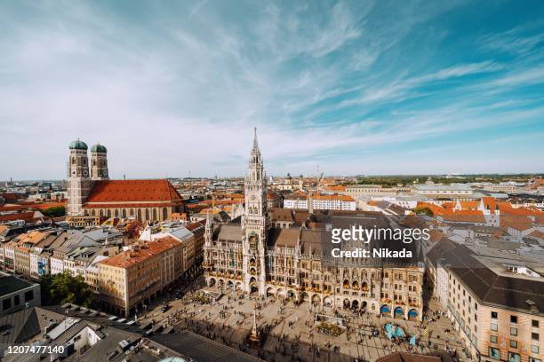 marienplatz square with new town hall and frauenkirche (cathedral of our lady). - munich stock pictures, royalty-free photos & images