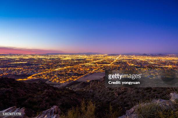 view of phoenix at dusk from south mountain - phoenix arizona stock pictures, royalty-free photos & images