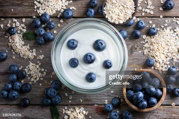 blueberries, oat flakes and yoghurt - yoghurt stock pictures, royalty-free photos & images