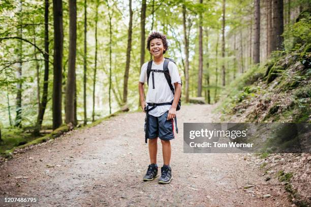 portrait of young boy smiling while hiking - smiling boy in tshirt stockfoto's en -beelden