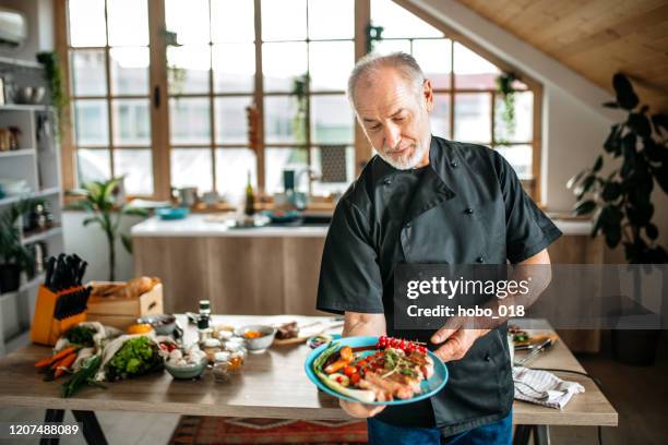 senior chef in his cozy kitchen - personal chef stock pictures, royalty-free photos & images