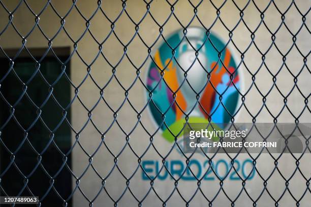 This photograph taken in Nyon on March 17 shows the Euro 2020 logo behind a fence at the headquarters of UEFA, the European football's governing...