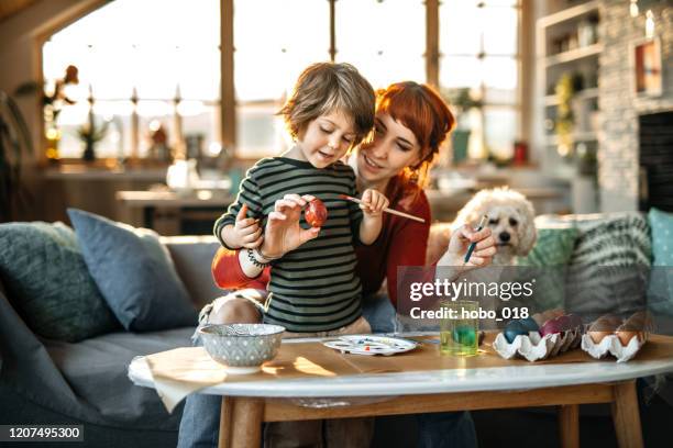 coloring eggs for easter celebration - dog easter imagens e fotografias de stock