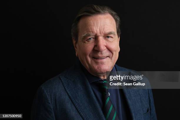 Former German Chancellor Gerhard Schroeder poses during brief photo session prior to speaking to foreign journalists at the Steigenberger Hotel on...