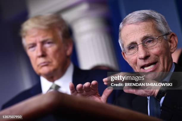 Dr. Anthony Fauci speaks as US President Donald Trump listens during the daily press briefing on the Coronavirus pandemic situation at the White...