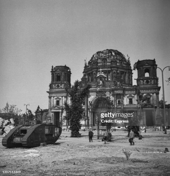 First World War British Mark V tank stands abandoned outside the bomb damaged ruins of the Berlin Cathedral following the allied occupation in July...