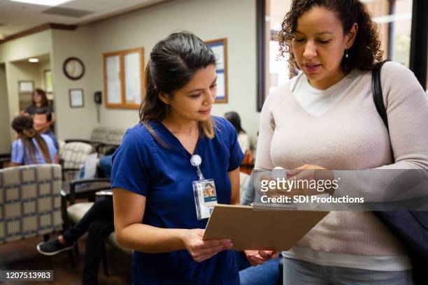 nurse talks with female patient about prescription medication - er visit stock pictures, royalty-free photos & images