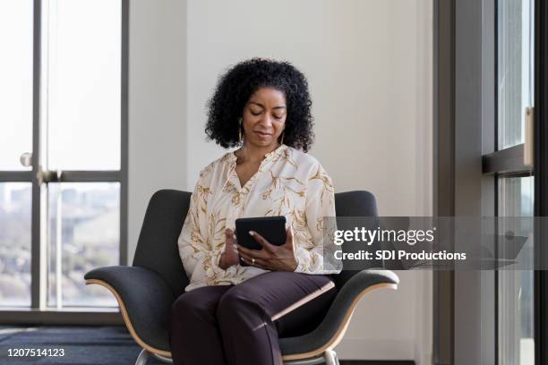 mature adult college professor relaxes in office after long day - lecturer online stock pictures, royalty-free photos & images