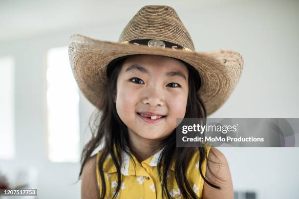 portrait of young girl wearing cowboy hat - cowboy hat stock pictures, royalty-free photos & images