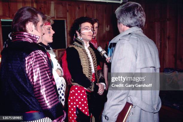 Members of English New Wave group Adam and the Ants are interviewed by an unidentified journalist backstage at the Palladium, New York, New York,...