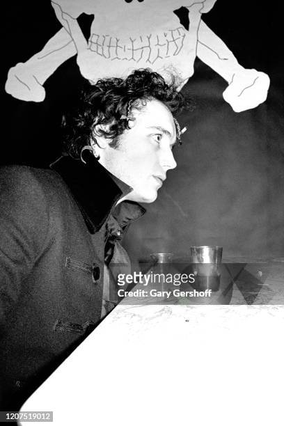 View of English New Wave musician Adam Ant , of the group Adam and the Ants, as he sits at a table in the Mudd Club, New York, New York, April 1,...