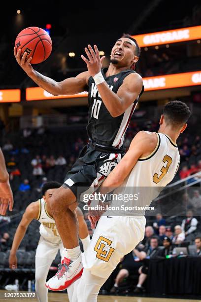 Washington State guard Isaac Bonton tries to score over Colorado Buffaloes guard Maddox Daniels during the first round game of the men's Pac-12...