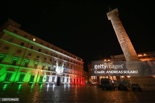 General view the colors of the Italian flag are projected onto the Palazzo Chigi government building in Rome on March 17 as a "sign of hope in this...