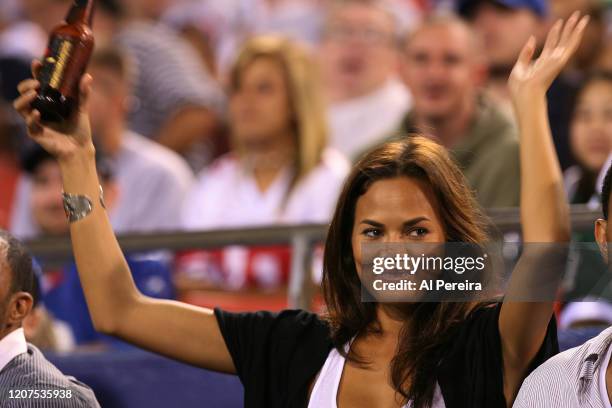 August 23: Musician John Legend and Model Chrissy Teigen share a beer when they attend the New York Jets vs New York Giants game at the Meadowlands...