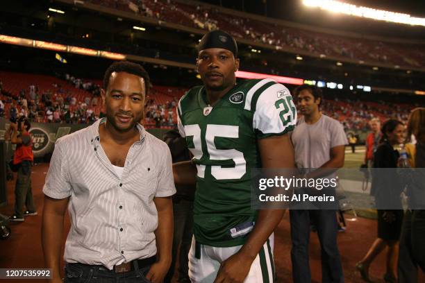 August 23: Musician John Legend meets with Safety Kerry Rhodes when he attends the New York Jets vs New York Giants game at the Meadowlands on August...